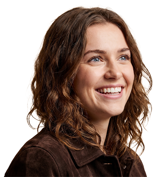 A smiling patient in a suede jacket