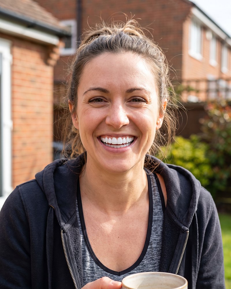A patient smiling in her garden after a run
