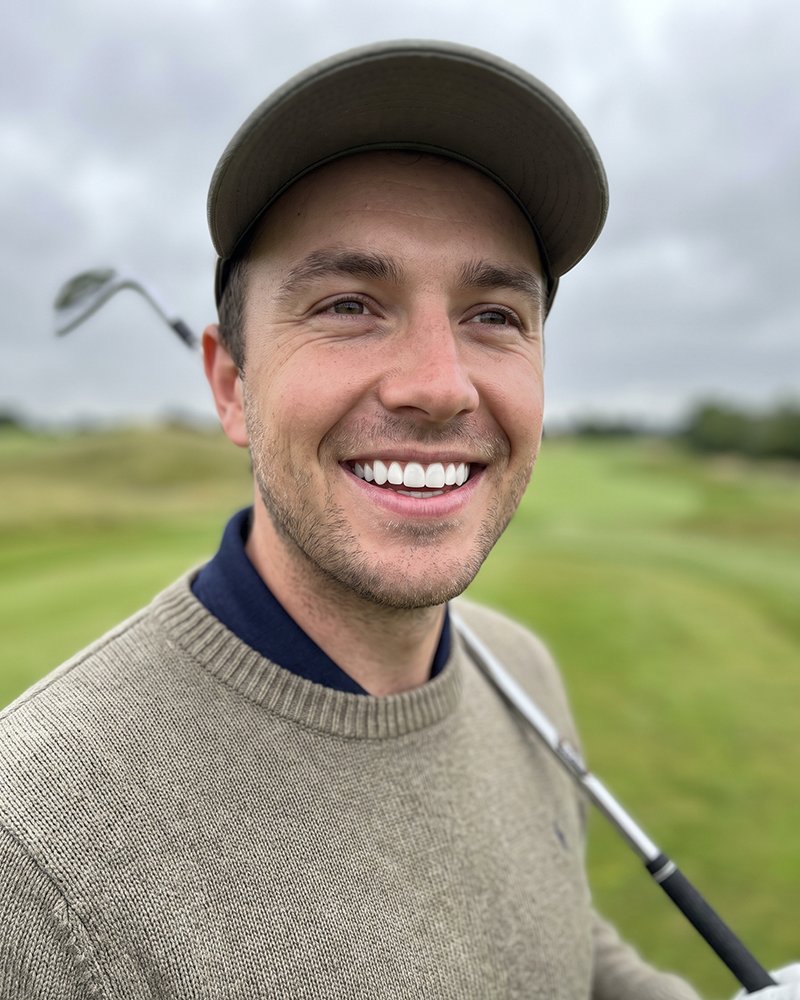 A patient smiling on the golf course